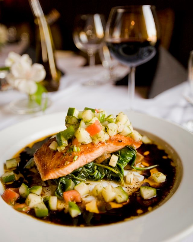Salmon course with a glass of red wine