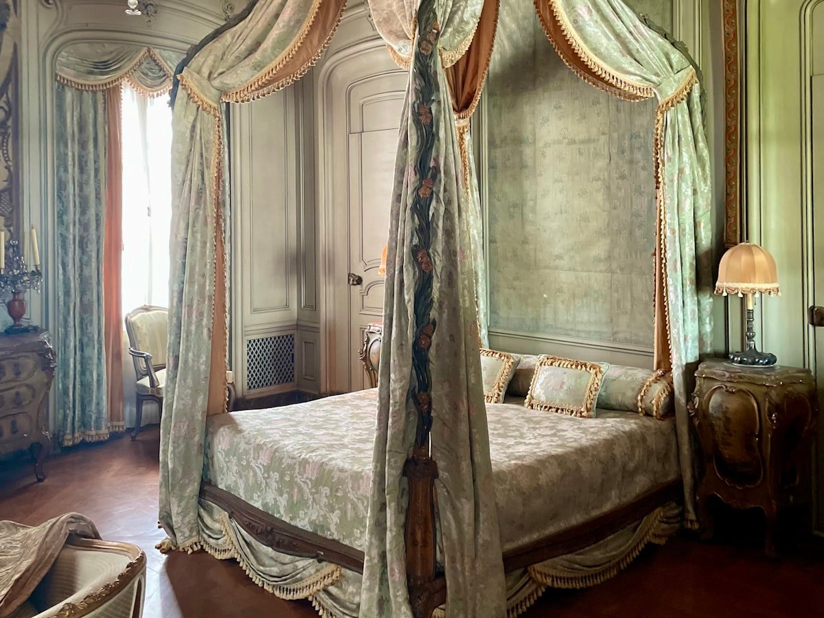 Canopy bed and chandelier in the historic Donjon Tower Suite